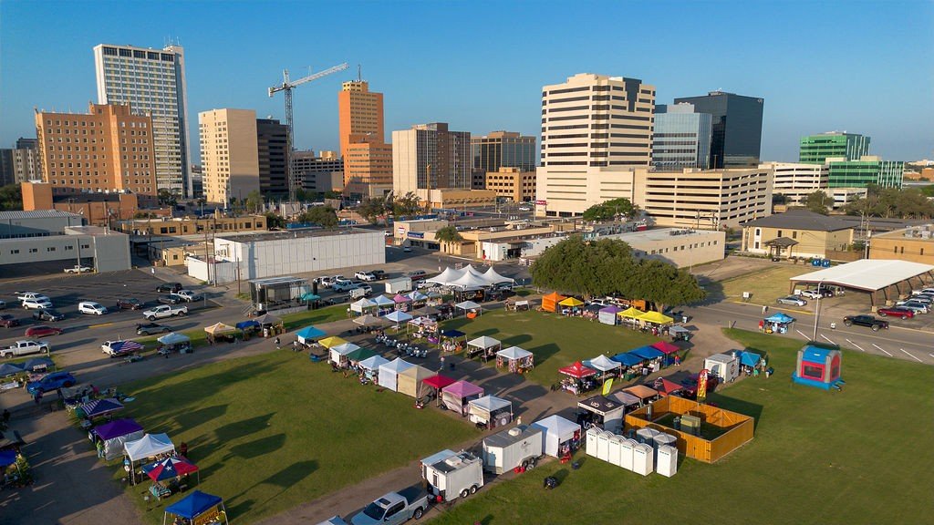 Aerial view of downtown Midland with tents and crowds on the lawn during Arts & Culture Day