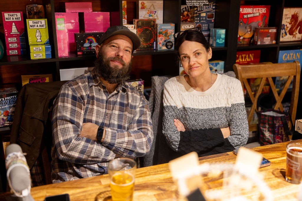 Two guests smiling at a table at The Waystone during the crawl