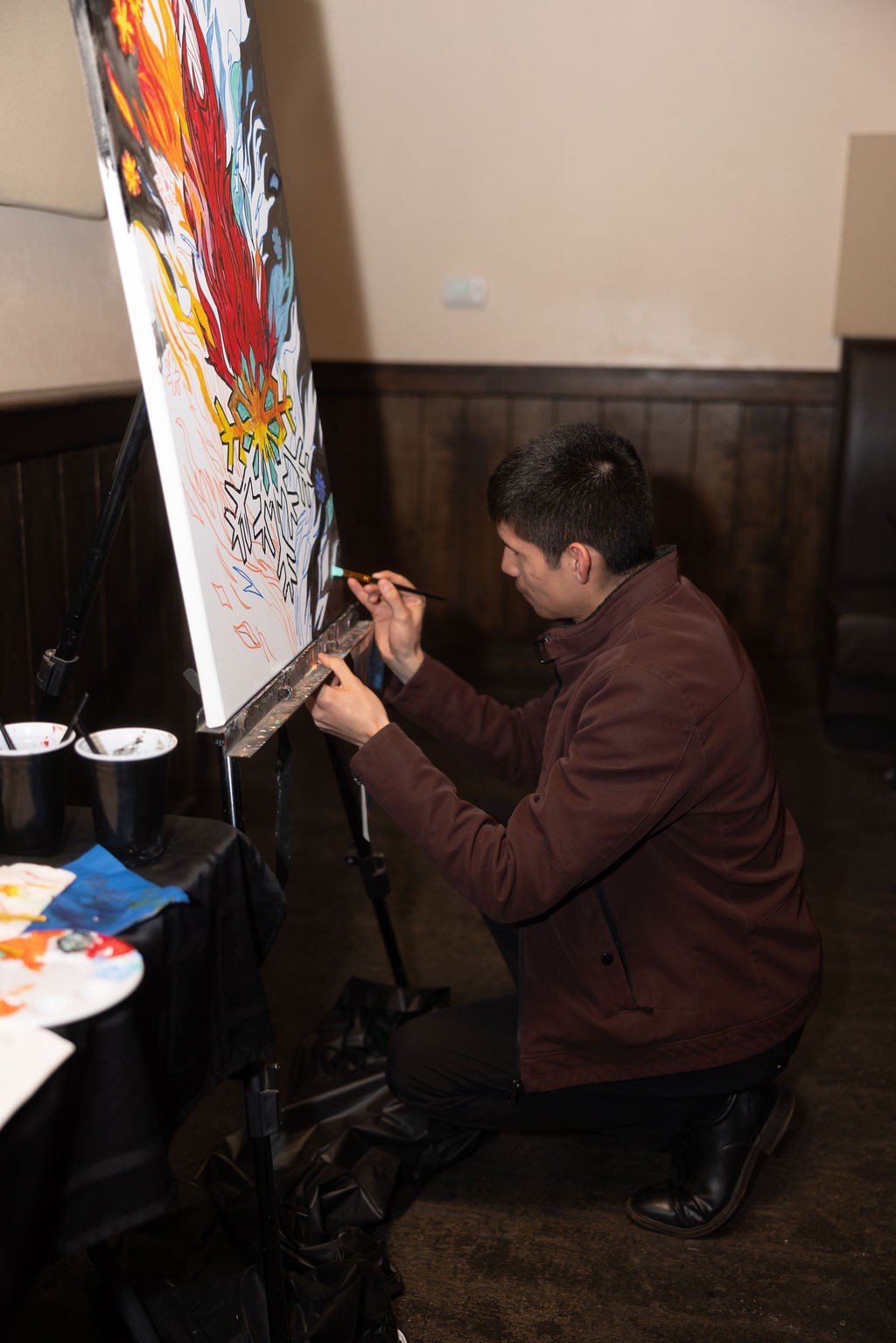 Artist painting a large canvas on an easel